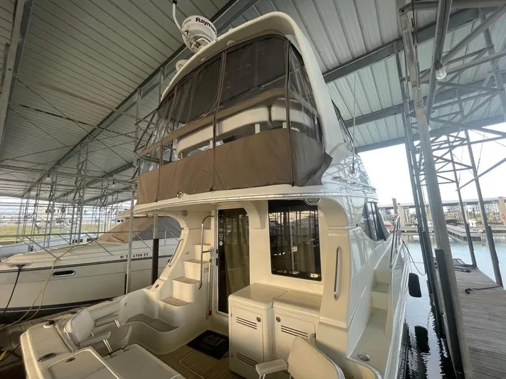 Open Time Yacht Photos Pics 2006 Silverton 34 Convertible yacht docked in a covered marina.