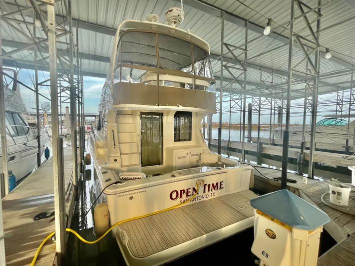 Open Time Yacht Photos Pics 2006 Silverton 34 Convertible yacht docked in marina, rear view.