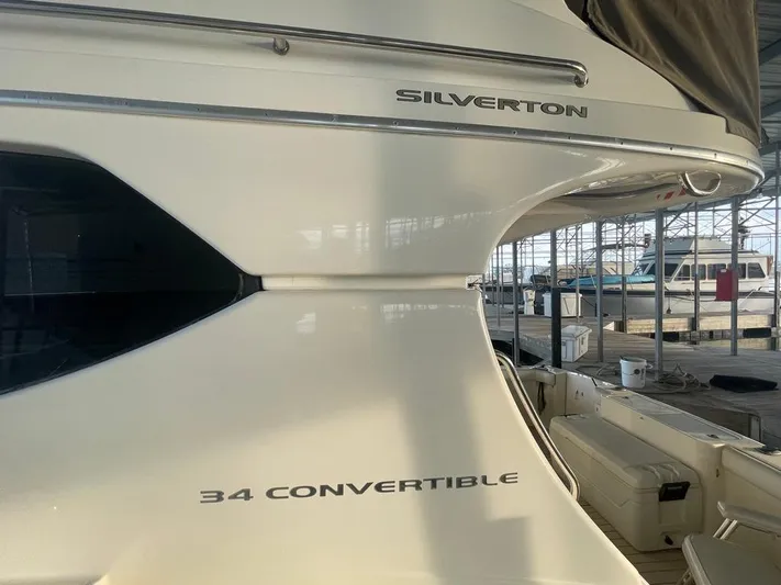 Open Time Yacht Photos Pics 2006 Silverton 34 Convertible yacht docked in a marina.