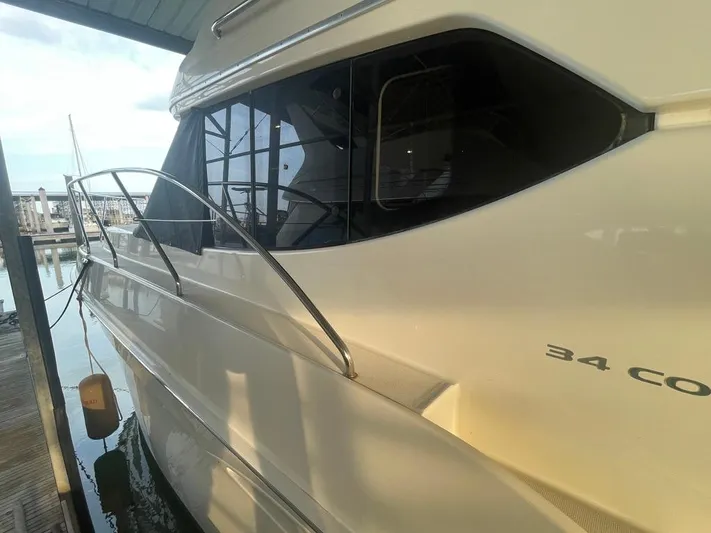 Open Time Yacht Photos Pics 2006 Silverton 34 Convertible yacht docked at marina, side view.