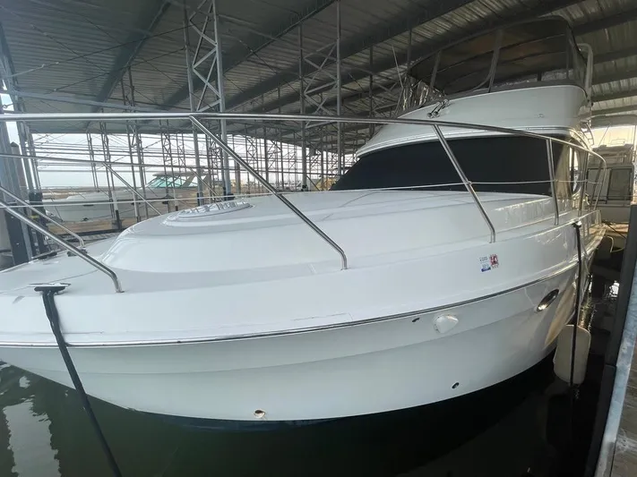 Open Time Yacht Photos Pics 2006 Silverton 34 Convertible yacht docked in a covered marina.