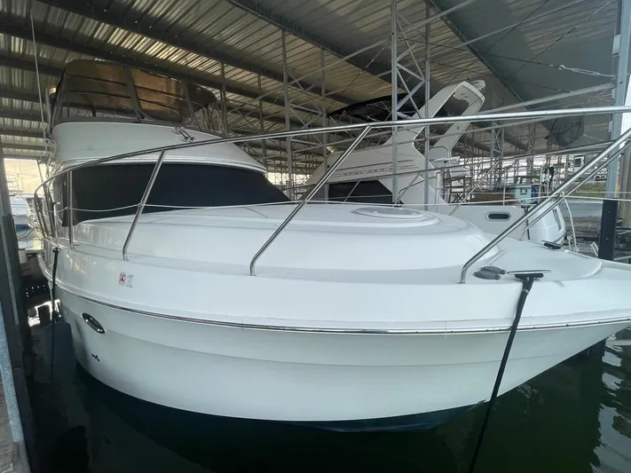 Open Time Yacht Photos Pics 2006 Silverton 34 Convertible yacht docked in a covered marina.