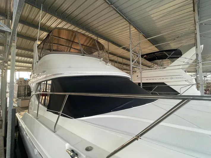 Open Time Yacht Photos Pics 2006 Silverton 34 Convertible yacht docked in a covered marina.