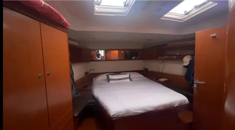 Yacht Photos Pics Luxurious cabin interior of 2011 Beneteau Oceanis 58 yacht with skylights and wooden furnishings.