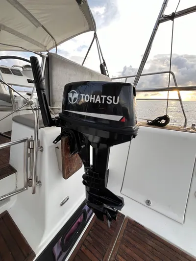  Yacht Photos Pics Tohatsu outboard motor on 2011 Beneteau Oceanis 58 sailboat deck at sunset.