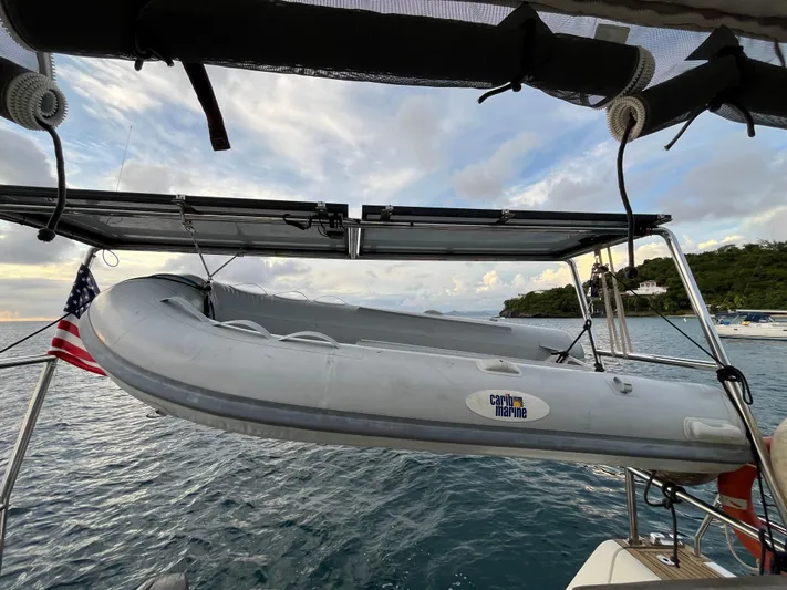  Yacht Photos Pics Inflatable dinghy on Beneteau Oceanis 58 sailboat, 2011 model, with scenic ocean backdrop.