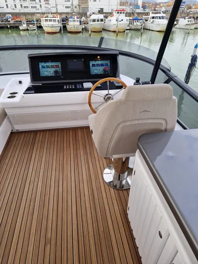  Yacht Photos Pics 2025 Azimut Magellano 60 yacht helm with modern controls and wooden deck.