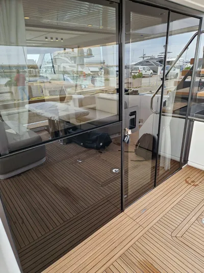  Yacht Photos Pics 2025 Azimut Magellano 60 yacht with sleek glass doors and elegant wooden deck.