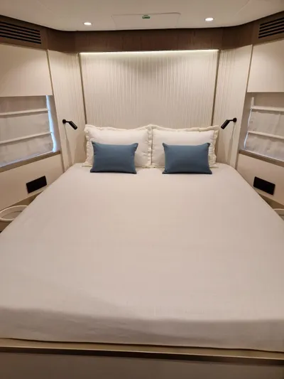  Yacht Photos Pics Luxurious bedroom interior of 2025 Azimut Magellano 60 yacht with elegant bedding.