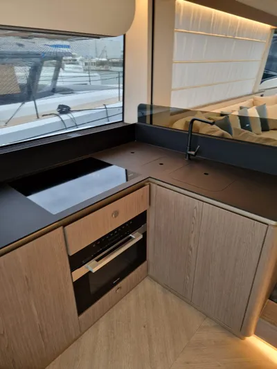 Yacht Photos Pics Modern kitchen interior of 2025 Azimut Magellano 60 yacht with sleek design and appliances.