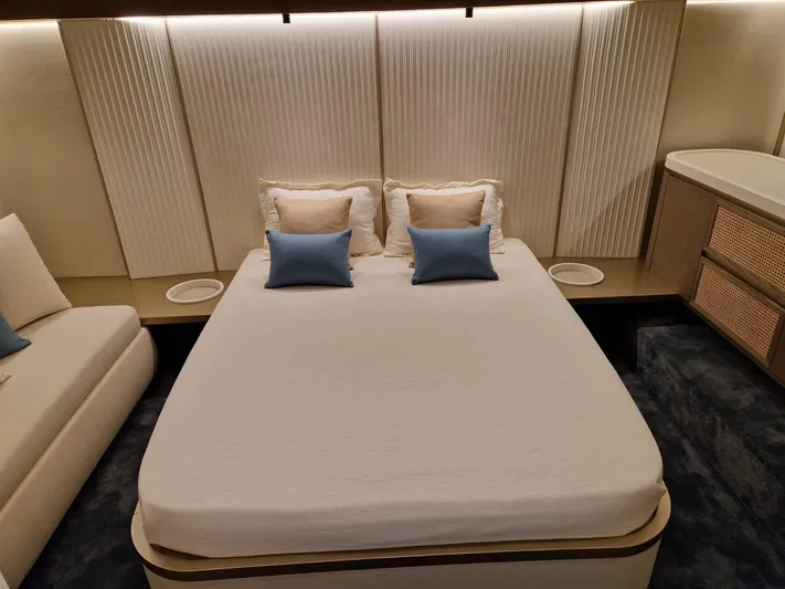  Yacht Photos Pics Luxurious bedroom interior of 2025 Azimut Magellano 60 yacht with modern design and cozy bedding.