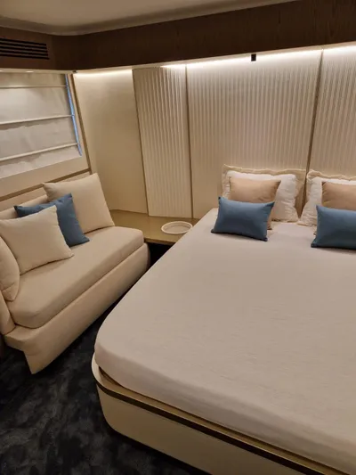  Yacht Photos Pics Luxurious bedroom in 2025 Azimut Magellano 60 yacht with elegant decor and plush seating.