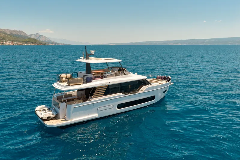  Yacht Photos Pics 2025 Azimut Magellano 60 yacht cruising on open sea under clear skies.