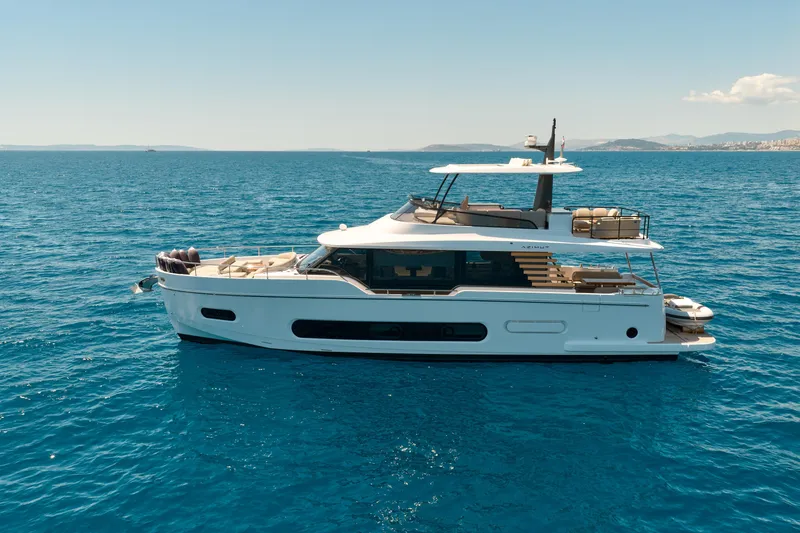  Yacht Photos Pics 2025 Azimut Magellano 60 yacht cruising on clear blue ocean waters.