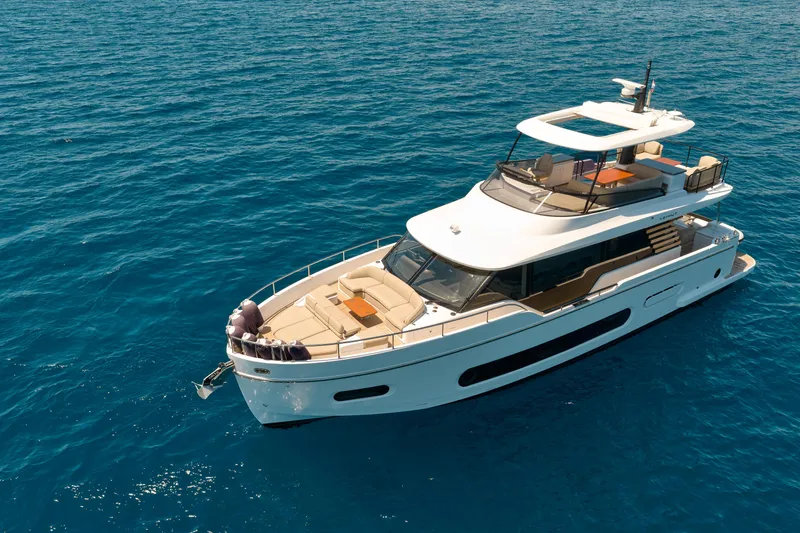  Yacht Photos Pics 2025 Azimut Magellano 60 yacht cruising on clear blue ocean waters.