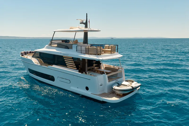  Yacht Photos Pics 2025 Azimut Magellano 60 yacht cruising on open sea, showcasing luxury design and spacious deck.