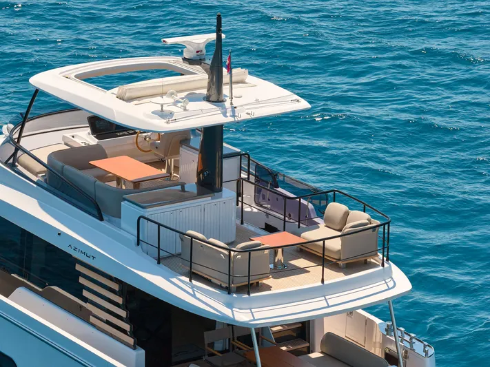  Yacht Photos Pics Azimut Magellano 60 yacht, 2025 model, featuring luxurious deck seating on open sea.