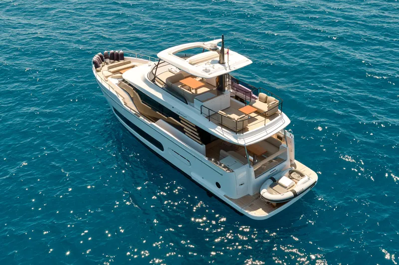  Yacht Photos Pics 2025 Azimut Magellano 60 yacht cruising on clear blue ocean waters.