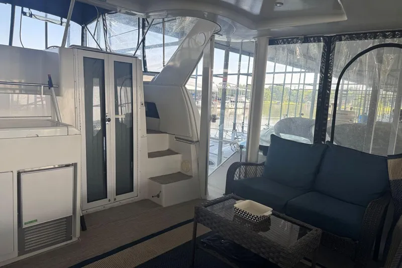  Yacht Photos Pics Interior of 1998 Carver 405 Motor Yacht with seating and stairs, featuring large windows.