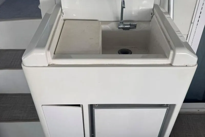  Yacht Photos Pics 1998 Carver 405 Motor Yacht sink with faucet, white cabinetry, and steps in background.