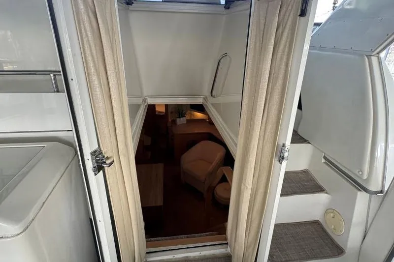  Yacht Photos Pics Interior view of 1998 Carver 405 Motor Yacht, showing stairs and cozy seating area.