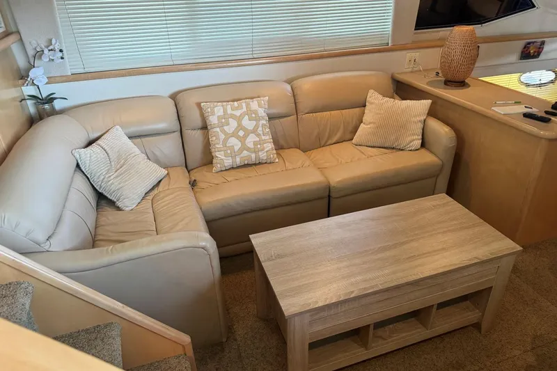  Yacht Photos Pics Interior of 1998 Carver 405 Motor Yacht with beige leather sofa and wooden table.