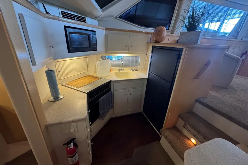  Yacht Photos Pics Compact kitchen area in a 1998 Carver 405 Motor Yacht with modern amenities.