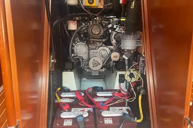 Plein Air Yacht Photos Pics Engine compartment of a 2006 Beneteau 423 sailboat with visible batteries and wiring.