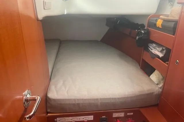 Plein Air Yacht Photos Pics Cozy cabin interior of 2006 Beneteau 423 sailboat with wooden finish and storage.