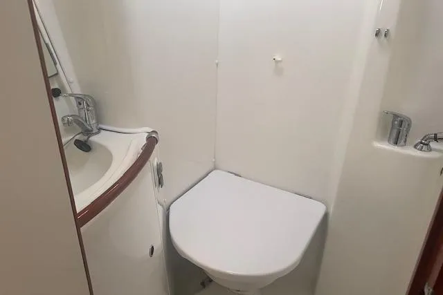 Plein Air Yacht Photos Pics Compact bathroom in 2006 Beneteau 423 yacht with sink and toilet.