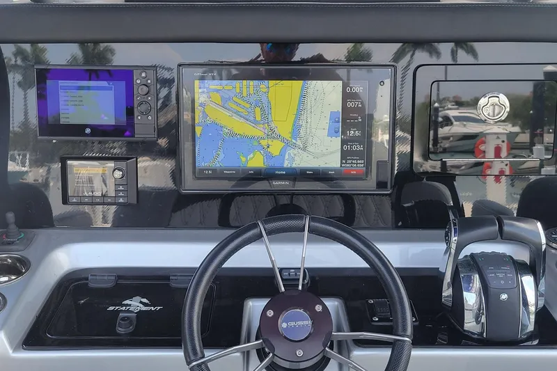  Yacht Photos Pics Control panel of 2019 Statement 380 Open boat with navigation screens and steering wheel.