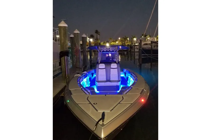  Yacht Photos Pics 2019 Statement 380 Open boat with blue LED lights docked at night.