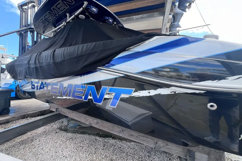  Yacht Photos Pics 2019 Statement 380 Open boat with cover, docked on a wooden platform.