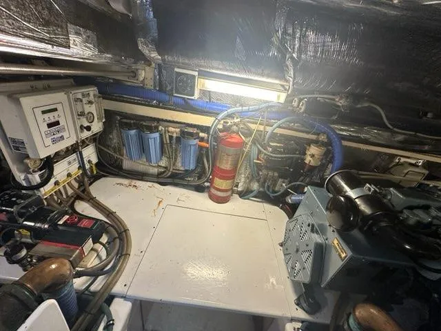 Mirabella Yacht Photos Pics Engine room of 1996 Tiara Yachts 43 Open, featuring equipment and fire extinguisher.