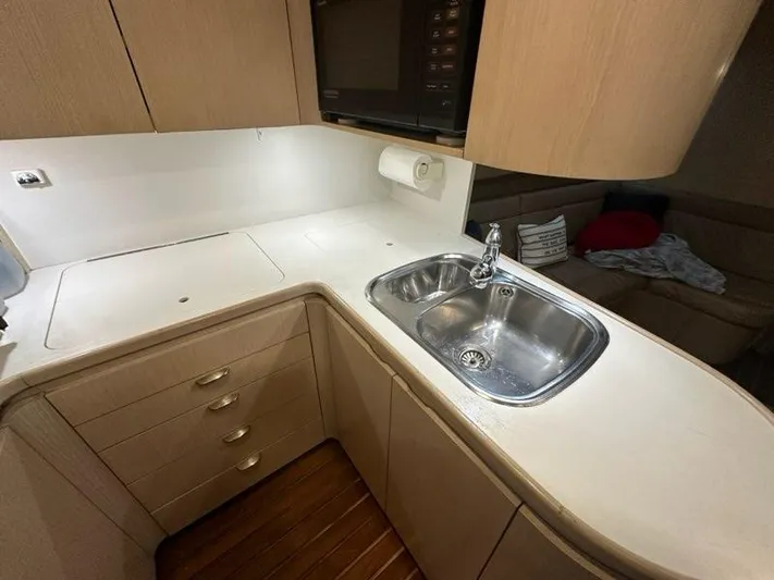 Mirabella Yacht Photos Pics 1996 Tiara Yachts 43 Open kitchen with sink, cabinets, and microwave.