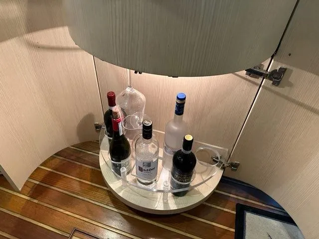 Mirabella Yacht Photos Pics Liquor cabinet on 1996 Tiara Yachts 43 Open with assorted bottles and glasses.