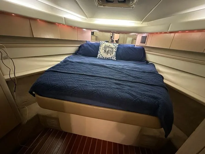 Mirabella Yacht Photos Pics Cozy cabin interior of 1996 Tiara Yachts 43 Open with blue bedding.