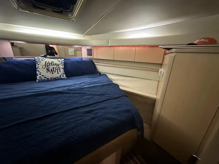 Mirabella Yacht Photos Pics Cozy cabin interior of 1996 Tiara Yachts 43 Open with blue bedding and nautical decor.