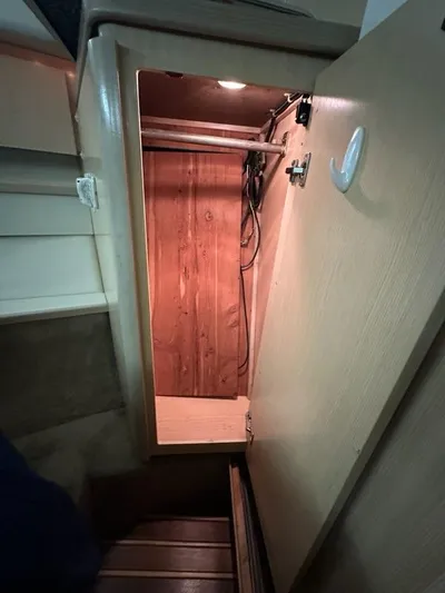 Mirabella Yacht Photos Pics 1996 Tiara Yachts 43 Open interior cabinet with wooden finish and lighting.