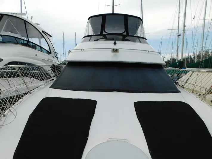 Justified Insanity II Yacht Photos Pics 2003 Carver 444 Cockpit Motor Yacht docked at marina, front view.