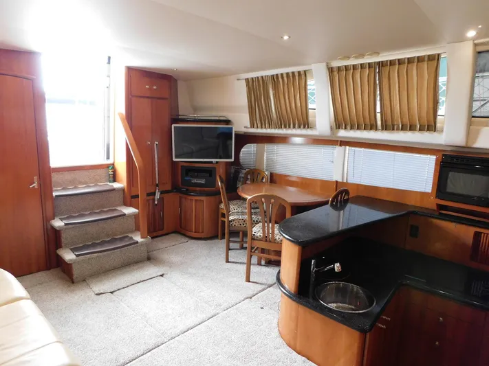 Justified Insanity II Yacht Photos Pics Interior of 2003 Carver 444 Cockpit Motor Yacht with kitchen and dining area.