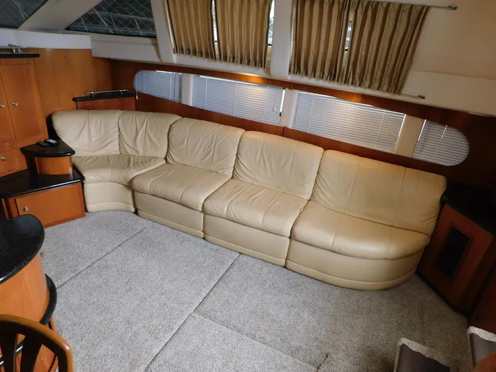 Justified Insanity II Yacht Photos Pics Luxurious interior of 2003 Carver 444 Cockpit Motor Yacht with beige leather sofa.