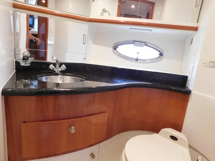 Justified Insanity II Yacht Photos Pics Luxurious bathroom in 2003 Carver 444 Cockpit Motor Yacht with sleek countertop and modern fixtures.