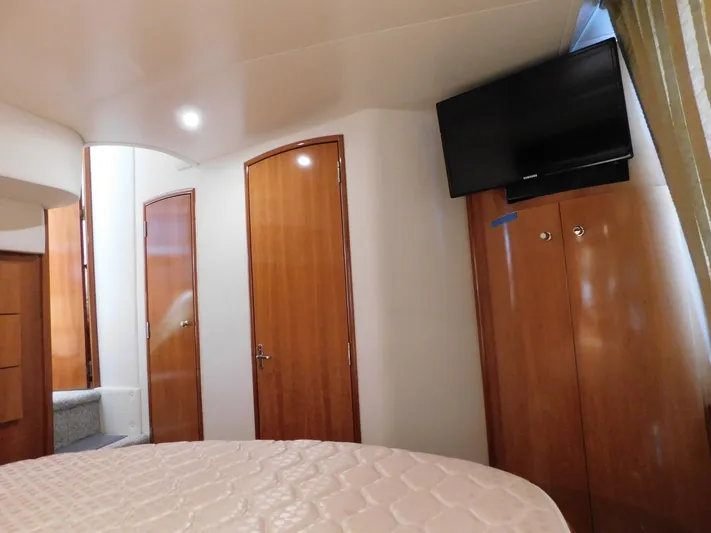 Justified Insanity II Yacht Photos Pics Interior of 2003 Carver 444 Cockpit Motor Yacht with wood doors and mounted TV.