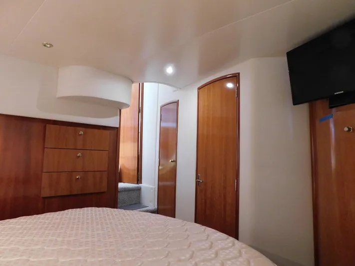 Justified Insanity II Yacht Photos Pics Interior of 2003 Carver 444 Cockpit Motor Yacht with wood paneling and TV.