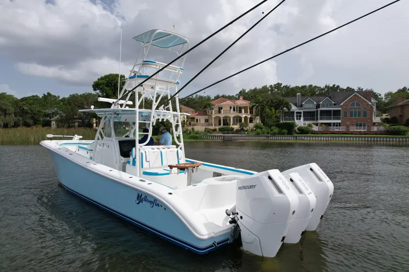  Yacht Photos Pics 2016 Yellowfin 39 Offshore boat with triple Mercury engines on a scenic waterway.