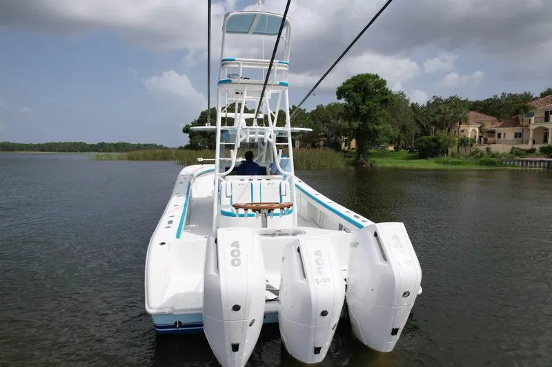  Yacht Photos Pics 2016 Yellowfin 39 Offshore boat with four powerful outboard engines on a calm lake.
