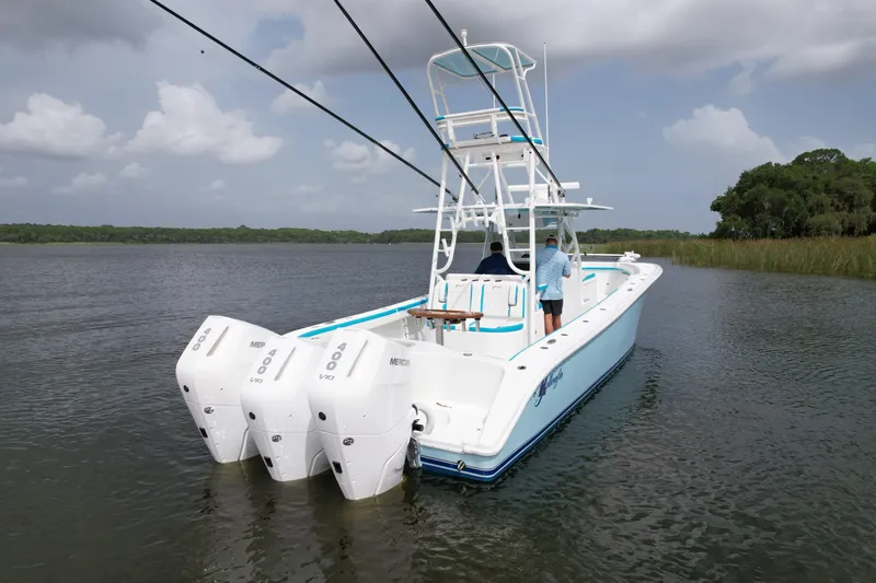  Yacht Photos Pics 2016 Yellowfin 39 Offshore boat with triple outboard engines on calm water.