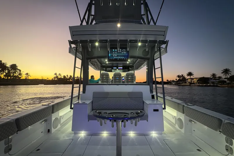  Yacht Photos Pics HCB 56 Suenos GIX 2026 boat at sunset, featuring illuminated deck and modern seating.