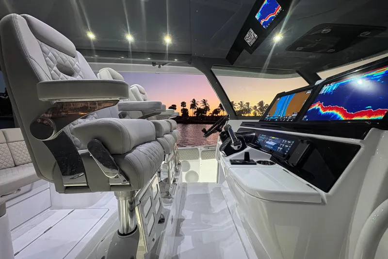  Yacht Photos Pics Luxurious helm of 2026 HCB 56 Suenos GIX with advanced navigation displays at sunset.